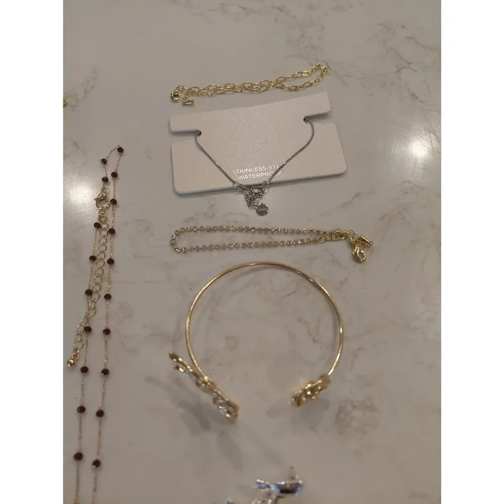 4 sets of earrings, 4 bracelets, and 7 necklaces which are all new.
